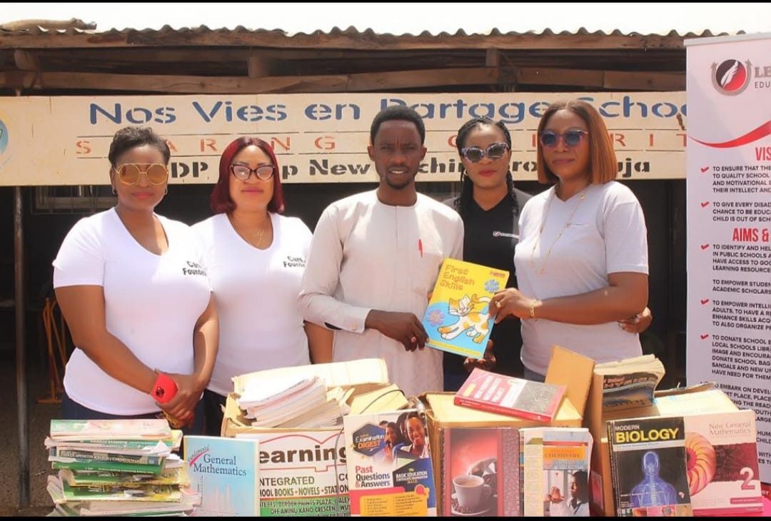 LEF with textbooks at Nos Vies en Partage School, New Kuchigoro IDP camp, Abuja.
